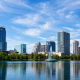 Orlando, Florida skyline during the day, reflected in water.