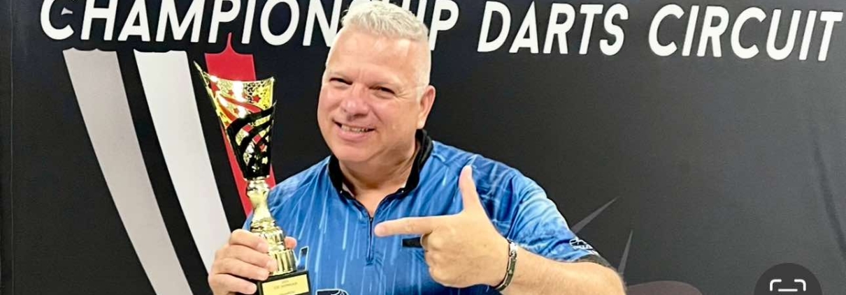 Darryl Christie holds trophy after CDC Showcase win