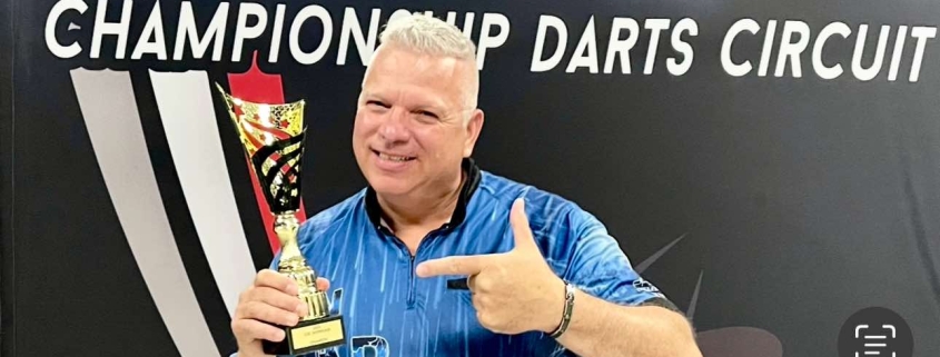 Darryl Christie holds trophy after CDC Showcase win